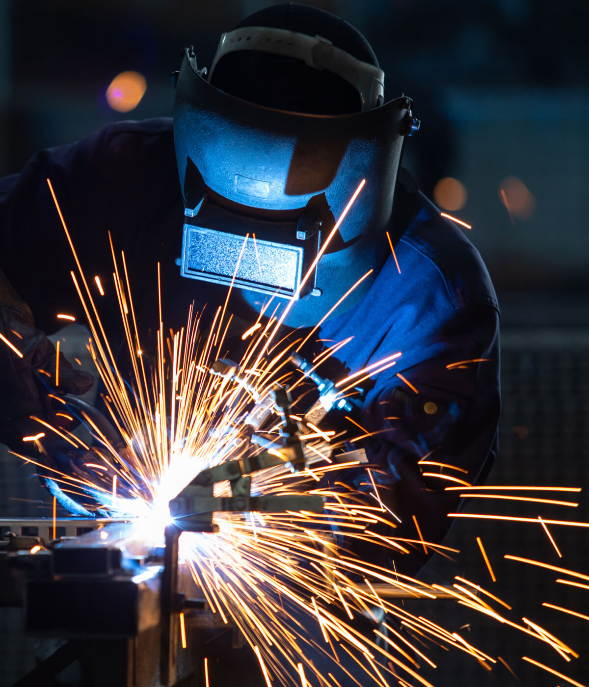 welder with sparks flying