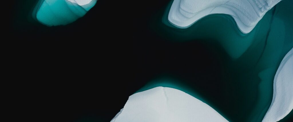 icebergs floating in water