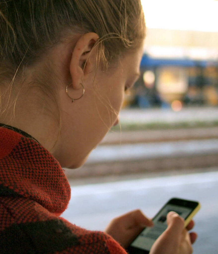 woman with phone using sms